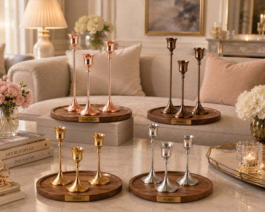 Éclat candle holder set available in rose gold, bronze, gold and silver finishes displayed in a luxury living room.