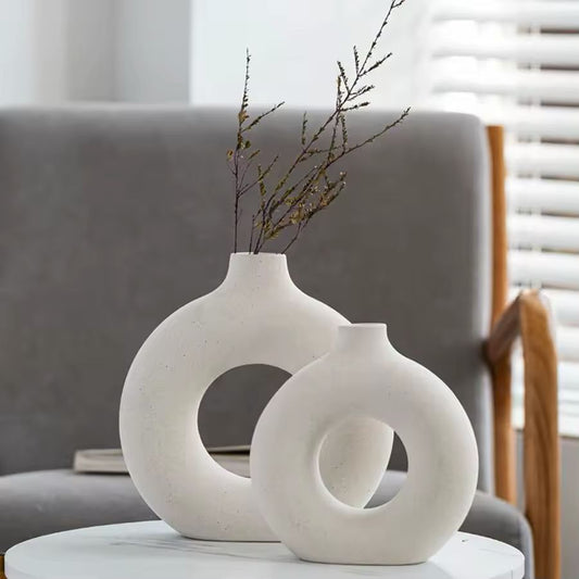 Set of two white Maison Donut ceramic vases displayed on a modern side table with minimalist home décor.