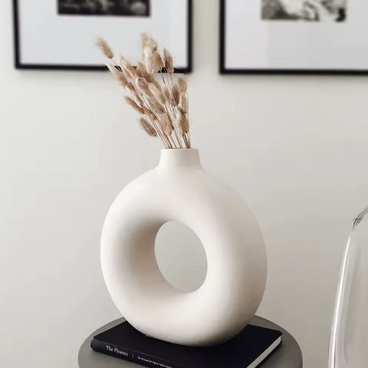 White Maison Donut ceramic vase with dried pampas grass on a modern minimalist table.
