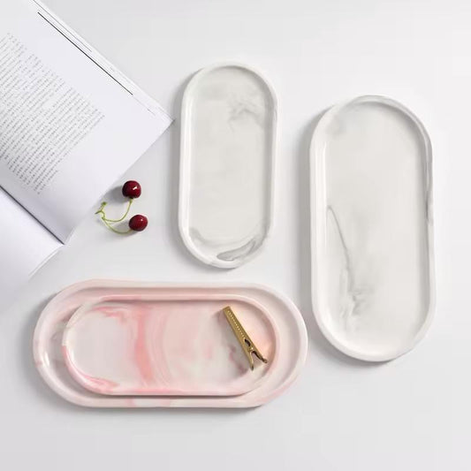 Luxury oval marble tray collection in white and pink for jewelry, perfumes and home décor by Maison Fleur.