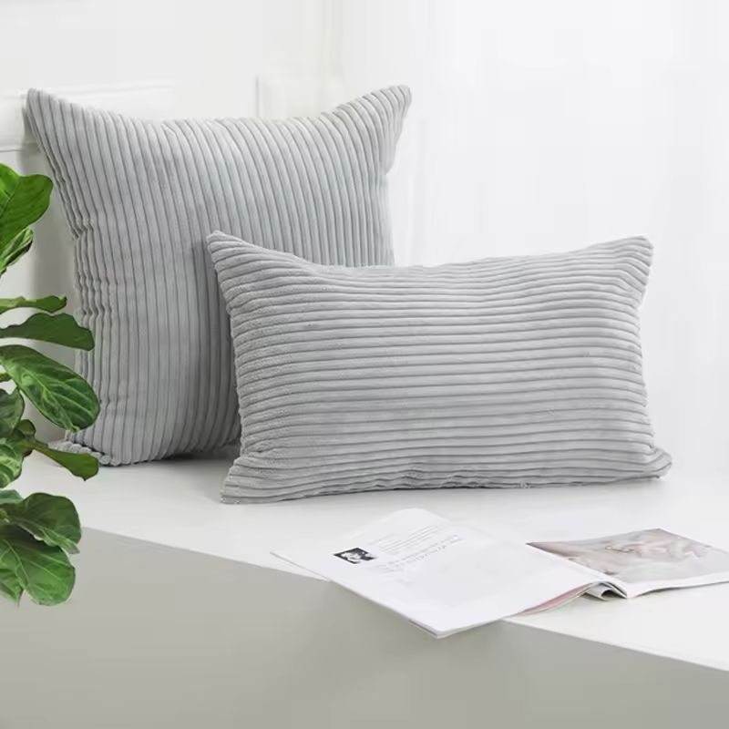 Grey velvet cushion cover styled in a contemporary living room.
